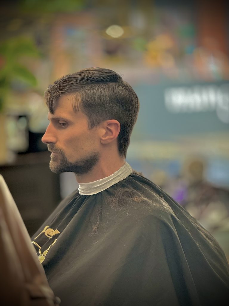 a man sitting in a barber shop