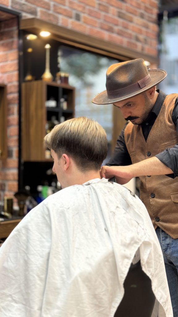 a man cutting a man's hair